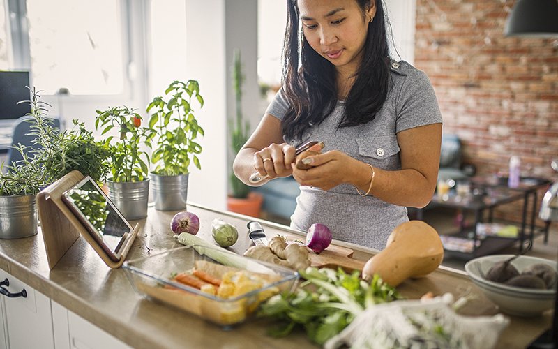 woman cutting vegetables for a meal